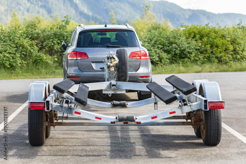 Billede på lærred Empty boat trailer connected to the car. Trailer for boats roots