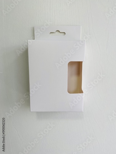 Front of retail display box with hook and cut out side.
minimal white retail packaging with a hang tab and die-cut window