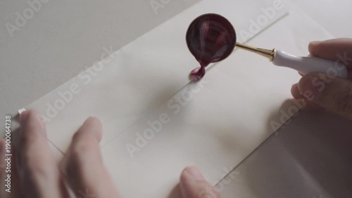 Sealing a vintage love letter with a red heart-shaped wax seal