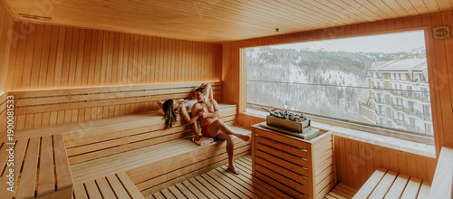 Women relax in sauna with v...