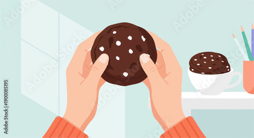 Hands holding a chocolate chip cookie with a mug of cookie batter nearby