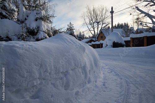 Konstfotografi Car completely covered with deep snow in a residential area during winter