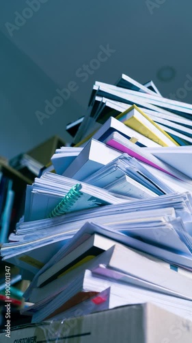 Stop motion sequence of books and business documents stacking up