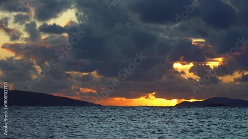 Magnificent sunset on a cloudy day over the Aegean Sea in autumn.	
