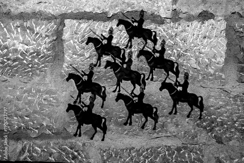 Billede på lærred The shadows of horsemen reflected on the wall