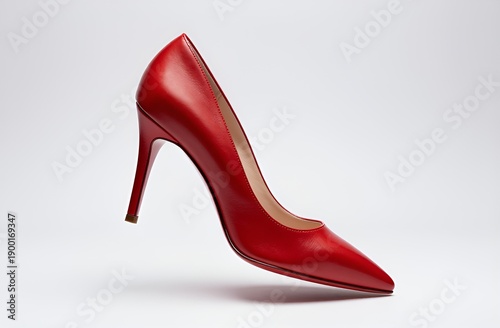 Vibrant red high-heeled shoe on white background