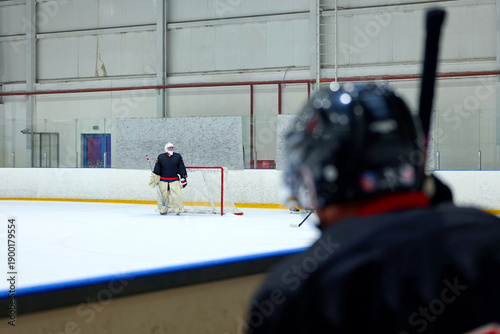 Photography A hockey player attacks an opponent's goalkeeper