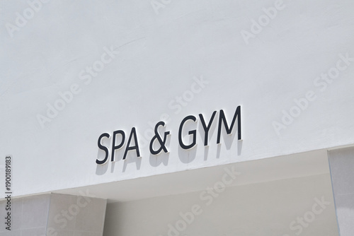 Foto Spa & Gym sign on stucco wall