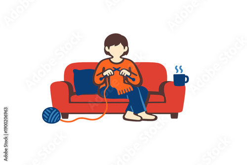 Person sits on red couch and knits while enjoying a warm drink and yarn in a cozy indoor setting during a relaxed afternoon