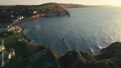 Drone footage of a chalky cliff coastline at sunrise