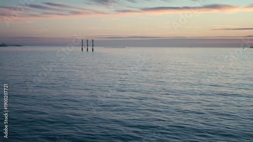 Looking out from a boat out in the sea at sunrise