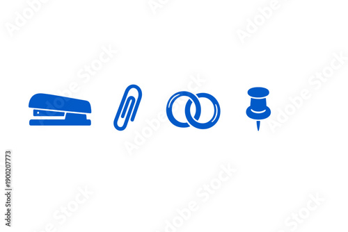 Various office supplies arranged in a row showing a stapler, paperclip, binder rings, and pushpin on a plain background
