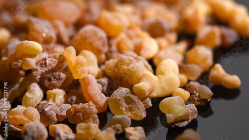Olibanum Frankincense resin, Boswellia sacra background. Frankincense or olibanum aromatic resin for incense and perfumes, rotating backdrop, design, macro shot 