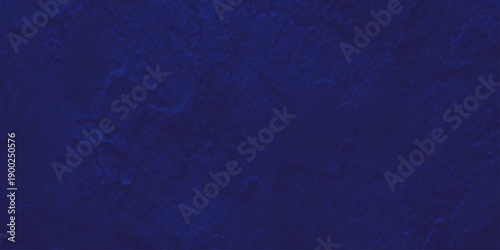 A dark blue grunge wall texture with a rough denim fabric pattern and old paper canvas material design on a textured cotton cloth surface backdrop