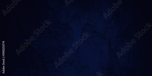 A dark blue grunge background with a vintage textured wall pattern featuring aged paint and a dirty blackboard surface for a blank design backdrop. indigo, black, board, grungy, chalk, closeup