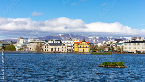 Canvas-taulu Reykjavik skyline with colorful buildings by Tjornin lake and Mount Esjan, Iceland
