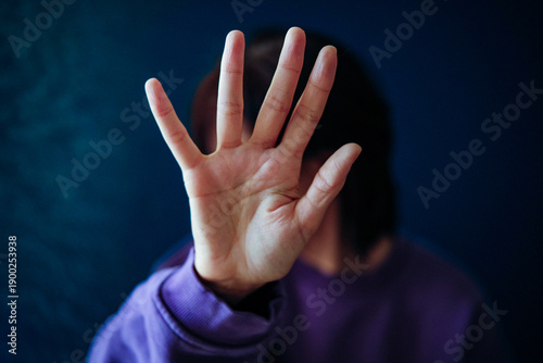 Fotografi Womans hand blocking face, showing refusal gesture