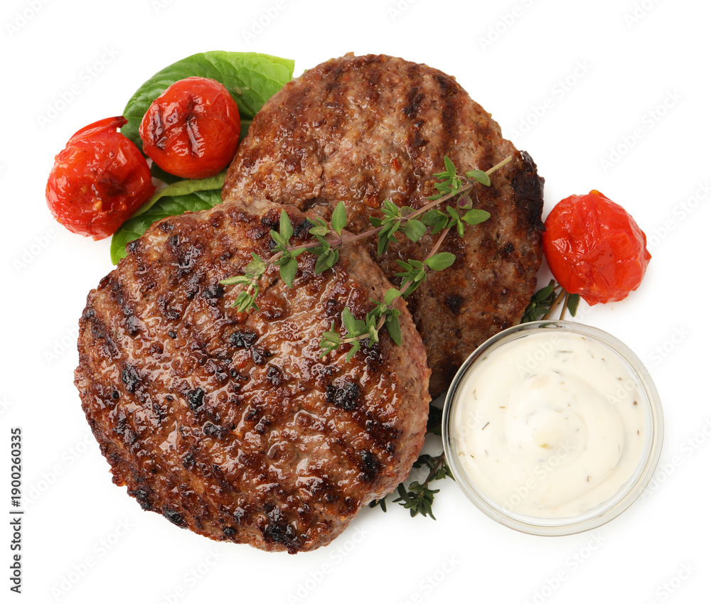 Fototapeta premium Delicious grilled meat patties, tomatoes, thyme, sauce and spinach isolated on white, top view