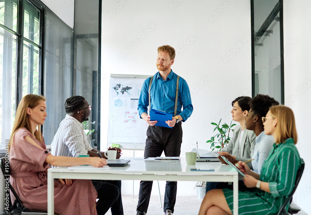 Obraz premium Group of young business people having a meeting or presentation and seminar with whiteboard in the office. Portrait of a young business man leader