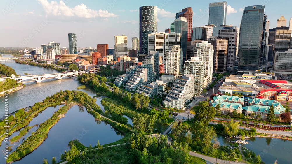 Naklejka premium Aerial sunset view of Calgary downtown skyline with dramatic sky and urban landscape