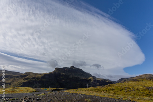 Solheimajokull mountain landscape under a massive lenticular wave cloud, Iceland