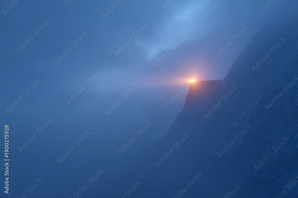 Obraz premium Mysterious mountain beacon illuminates foggy cliffside at night