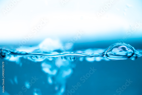 Cuadro en lienzo Blue water surface with air bubble and ripples, clean liquid background, freshness and purity concept, macro waterline in bright light