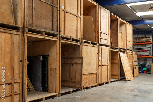 Quadro su tela Wooden Storage Crates Stacked in Professional Storage Warehouse