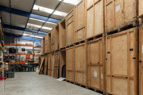 Fotografía Wooden storage crates lining aisle inside warehouse