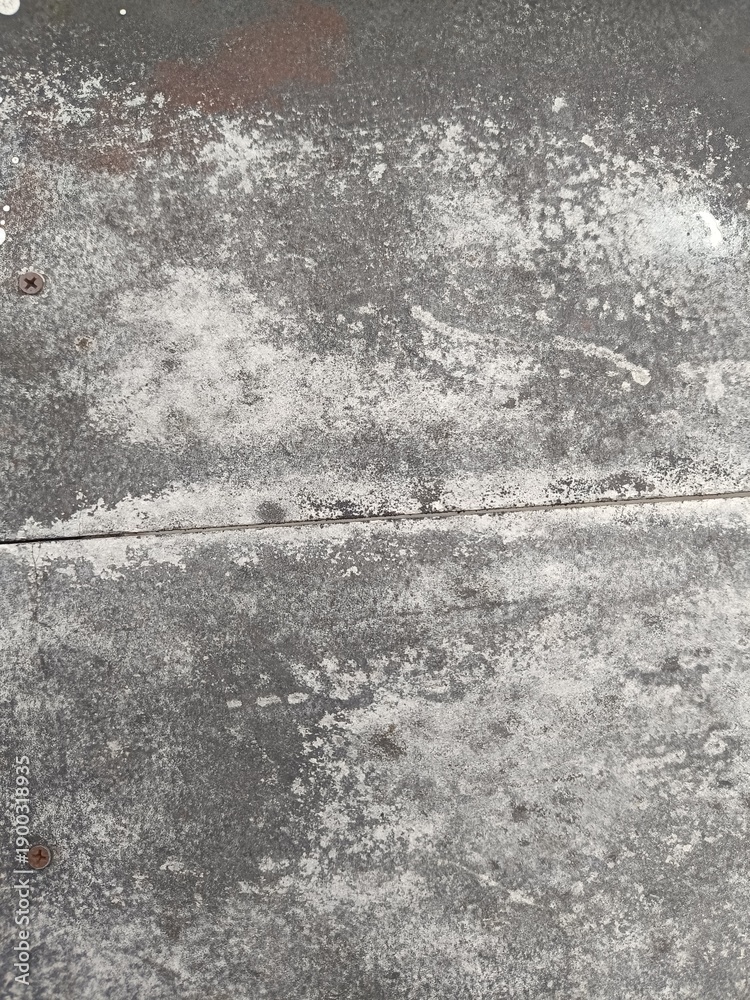 Obraz premium Grungy weathered concrete wall texture with rustic stains. Ideal for industrial backgrounds, vintage overlays, and architectural design projects seeking a raw, aged look.