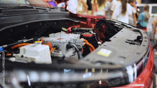 Electric vehicle engine bay revealing power components at an automotive exhibition