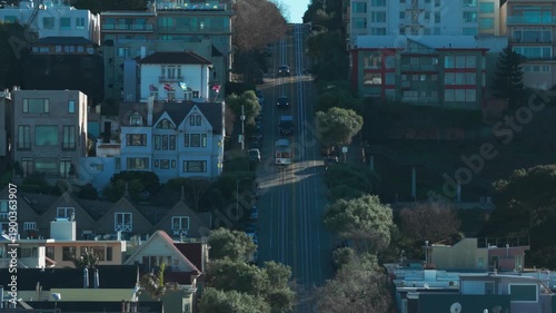 Aerial telephoto descending shot of a cable car going down steep Hyde Street in San Francisco, California. 4K