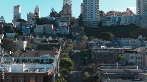 Low aerial shot flying over two cable cars passing each other on Hyde Street in San Francisco, California. 4K