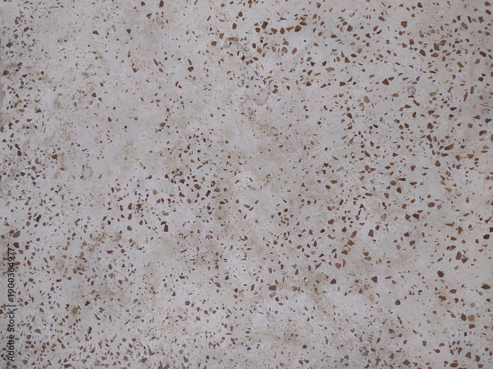 Obraz premium Elegant beige terrazzo texture with warm brown marble chips. High-quality seamless stone pattern for modern interior design and luxury backgrounds.