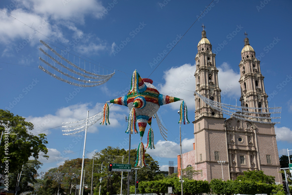 Obraz premium Tree foliage frames a beautiful church in downtown Villahermosa, Tabasco, Mexico.