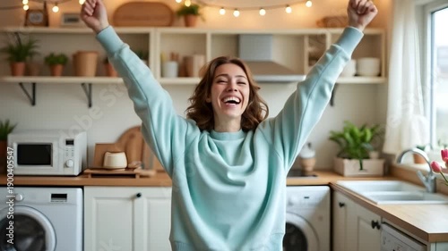Happy woman celebrating finished household chores in bright kitchen, positive home lifestyle, domestic success moment and joyful everyday living in modern interior