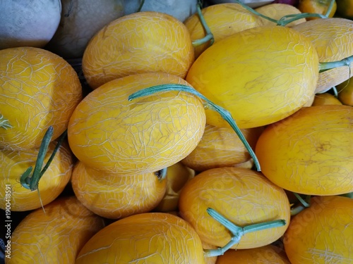a stack of yellow melon