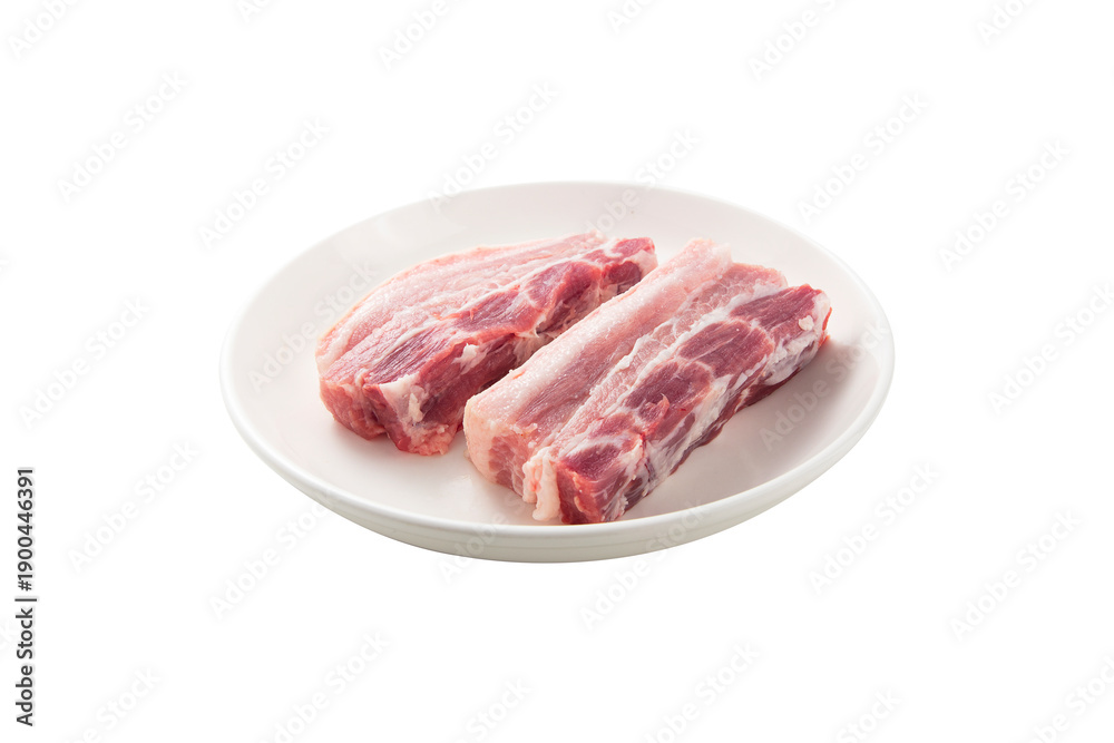 Obraz premium Two thick cuts of raw pork belly meat with visible fat and lean layers presented on a simple white plate against a pure white background