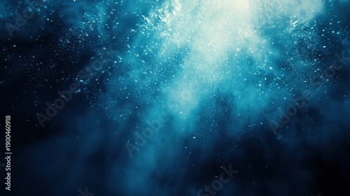 Abstract underwater scene with glowing light and shimmering particles in deep blue water