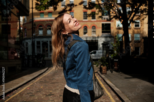 Happy tourist walking in london picturesque street