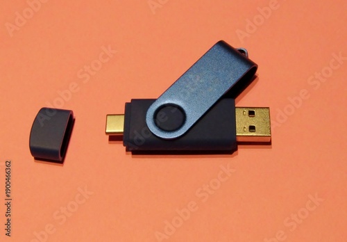Black dual USB flash drives on orange background