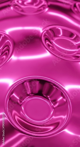Highly reflective magenta surface displays repeating circular indentations illuminated by bright light.