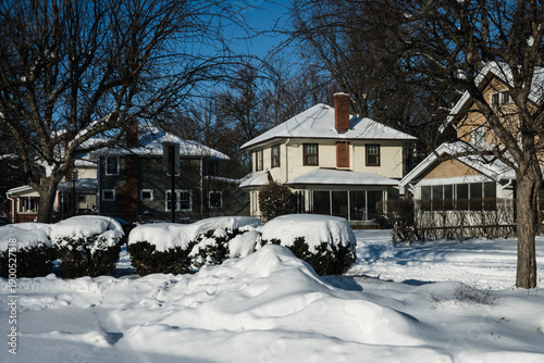 A view of a middle class neighborhood in snow after a blizzard in the MIdwest.