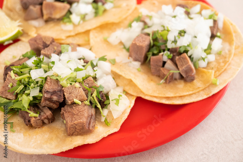 Authentic beef tongue tacos or tacos de lengua on corn tortilla with coriander, onion, and green sauce. Authentic mexican street food.