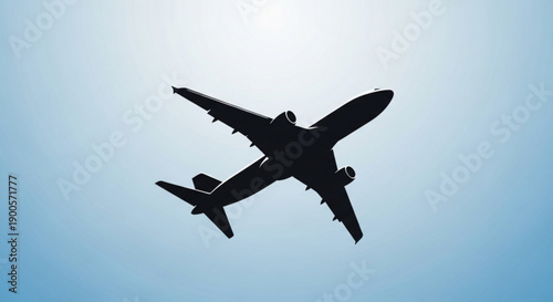 Airplane flying high in the clear blue sky viewed from below with wings spread wide