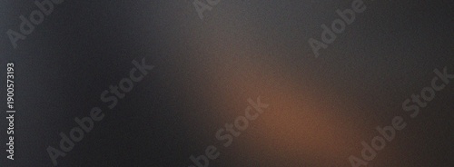 Fotografie Subtle abstract dark background featuring a warm brown light leak with a fine gr
