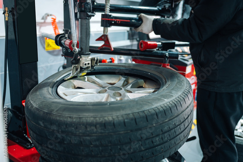 Wallpaper Mural Car Wheel Tire Being Mounted at Auto Repair Shop Torontodigital.ca