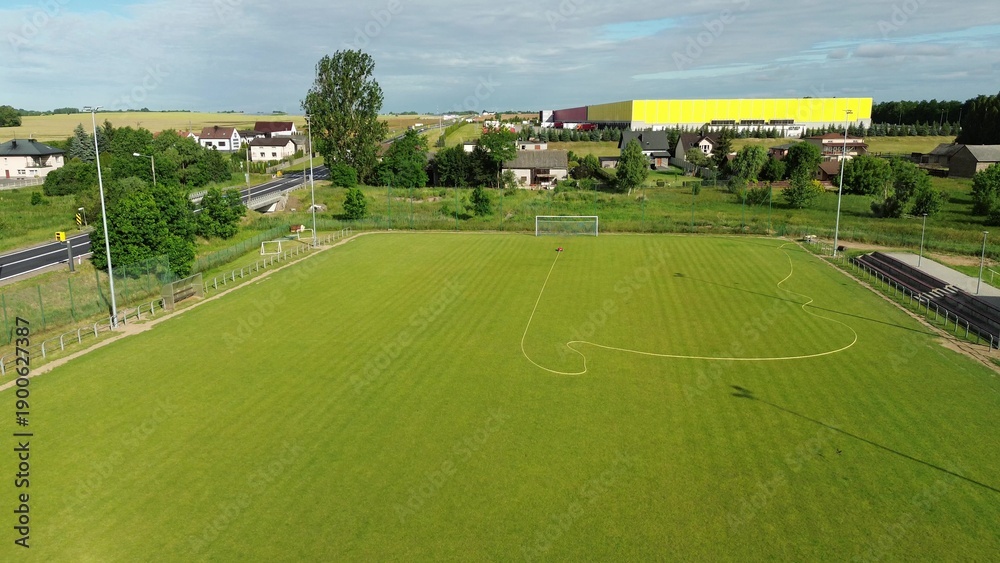 Naklejka premium Green soccer field maintenance with autonomous sprayer