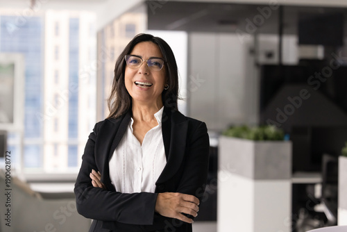Free Download Laughing middle-aged 60s businesswoman in elegant business attire look at camera, stands alone in corporate office, representing accounting, sales or marketing department Successful lady boss portrait - GFXLoad