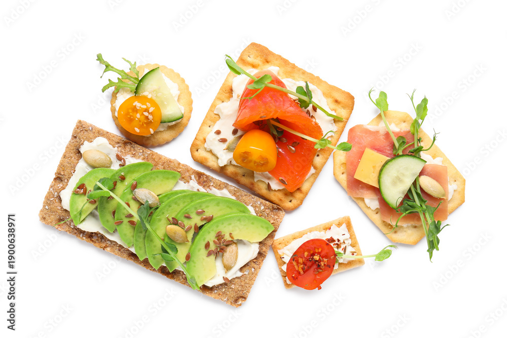 Fototapeta premium Different tasty crackers with cheese, avocado and salmon isolated on white background